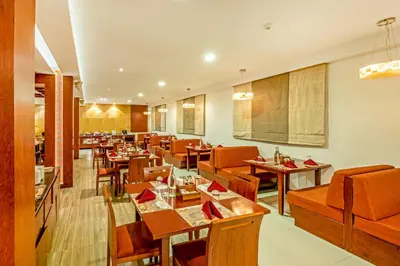 a restaurant with wooden tables and chairs and a dining room at Sterling Ooty Elk Hill in Ooty
