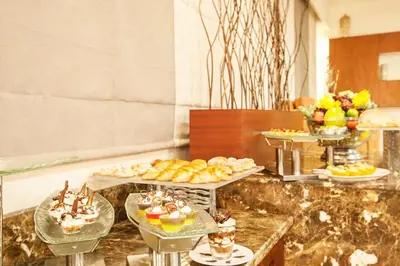 a buffet with several trays of food and desserts at Sterling Ooty Elk Hill in Ooty