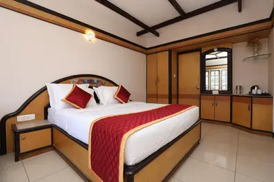 a bedroom with a large bed in a room at Hotel Silver Oak in Ooty