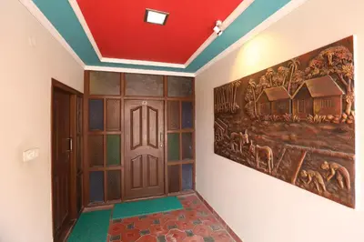 a hallway with a door and a painting on the wall at Hotel Silver Oak in Ooty