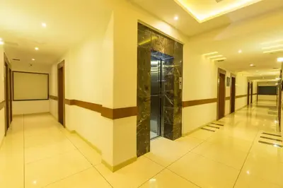 a hallway of a building with a elevator at Grand Plaza Suites in Kozhikode
