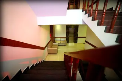 a staircase in a building with a stair case at Grand Plaza Suites in Kozhikode