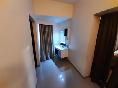a hallway of a hotel room with a bedroom at Meadows Residency in Ooty