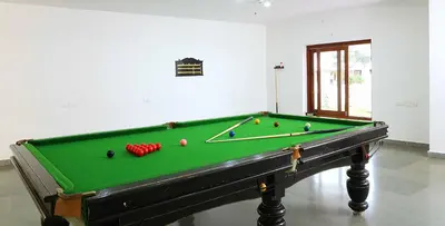 a pool table with balls on it in a room at Vythiri Village in Vythiri