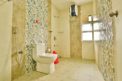 a bathroom with a toilet and a shower at Mystique stay resort in Kotagiri