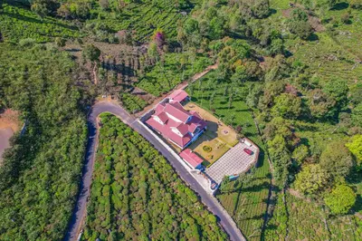 an aerial view of a house in the middle of a forest at Mystique stay resort in Kotagiri