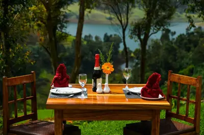 a wooden table with wine glasses and red napkins at Destiny - The Farm Resort in Ooty