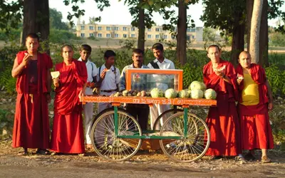 a group of people standing next to a fruit cart at Evolve Back Coorg in Siddapur
