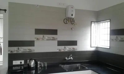 a kitchen with a sink and a window at Neo Nirmal Residency in Ooty