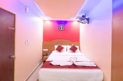 a bedroom with a bed with two towels on it at Sree Comforts in Kushālnagar