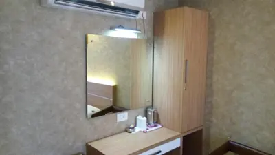 a bathroom with a sink and a mirror in a room at Hotel Kapilavasthu in Palakkad