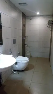 a bathroom with a toilet and a sink at Hotel Kapilavasthu in Palakkad