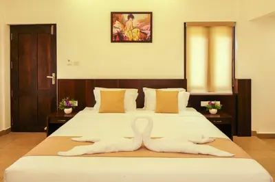 a bedroom with a bed with a swan made out of towels at The Serenity Resort in Tariyod