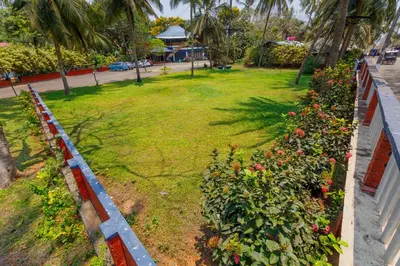 a row of plants with flowers in a yard at Kappad Beach Resort in Kappad