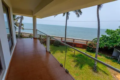 a balcony with a view of the ocean at Kappad Beach Resort in Kappad