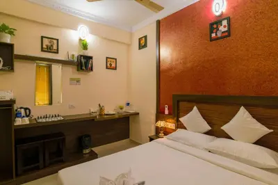 a bedroom with a large bed and a sink at Blue Bell Cochin Airport Hotel in Nedumbassery