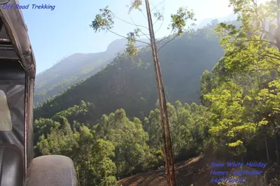 a view of a forest from the inside of a bus at Kanthalloor Homestay Snow White Holiday Homes in Kanthalloor