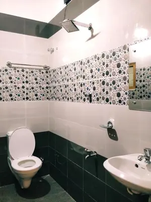 a bathroom with a toilet and a sink at Prajapuri Hotel in Trichūr