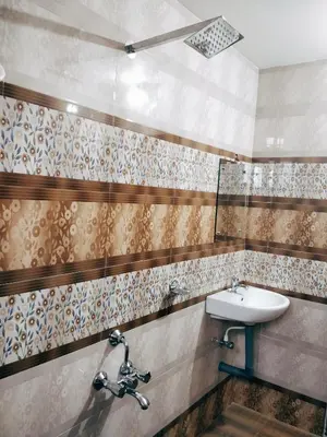 a bathroom with a sink and a mirror at Prajapuri Hotel in Trichūr