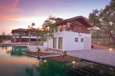 a house with a pool in front of it at The Serai Bandipur in Bandipūr