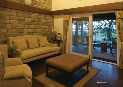 a living room with a couch and a table at The Serai Kabini in Begūr
