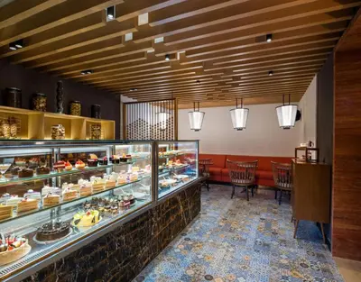 a bakery with a display case filled with pastries at The Residency Towers Coimbatore in Coimbatore
