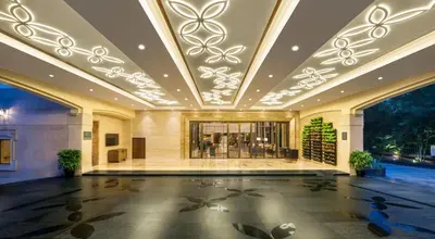 a lobby of a hotel with a large ceiling at The Residency Towers Coimbatore in Coimbatore