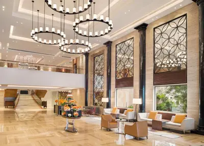 a lobby of a hotel with chandeliers at The Residency Towers Coimbatore in Coimbatore