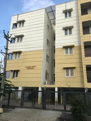 a building with a fence in front of it at Tulip Suites in Coimbatore