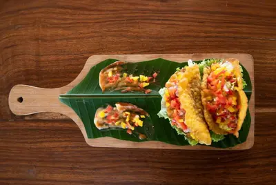 a plate of food on top of a banana leaf at Sixth Element in Kushālnagar