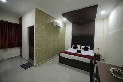 a bedroom with a bed and a wall at Shivalaya Residency in Trichūr