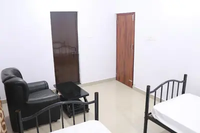 a waiting room with a chair and a table at Anamala Serenity Homestay Kerala in Lakkidi