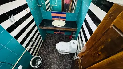 an overhead view of a bathroom with a sink and a toilet at Mountain View cottage in Ooty