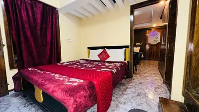 a bedroom with a bed with a red blanket at Mountain View cottage in Ooty