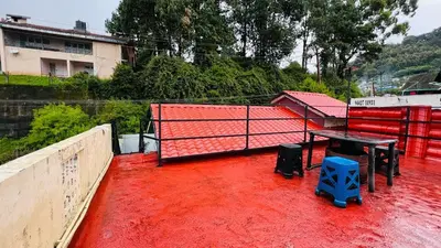 a ping pong table on top of a red floor at Mountain View cottage in Ooty