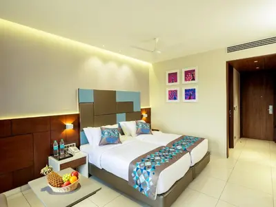 a bedroom with a large bed and a bowl of fruit at Hotel Divine Fort in Palani