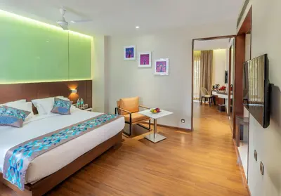 a hotel room with a bed and a desk at Hotel Divine Fort in Palani