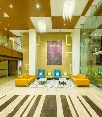 a lobby with couches and chairs in a building at Hotel Divine Fort in Palani