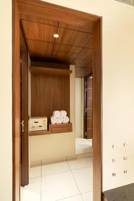 a room with a door with a shelf with towels at Hotel Divine Fort in Palani