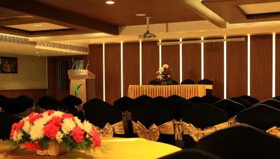 a conference room with chairs and a table with flowers at YASH INTERNATIONAL in Kozhikode
