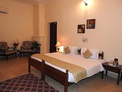 a bedroom with a large bed in a room at Ama Plantation Trails Coorg in Gonikoppal