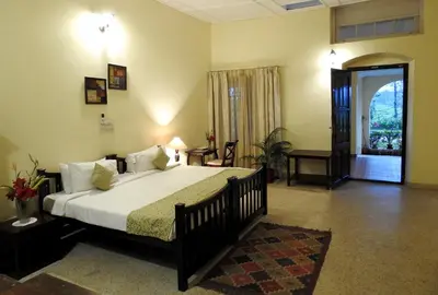 a bedroom with a large bed in a room at Ama Plantation Trails Coorg in Gonikoppal