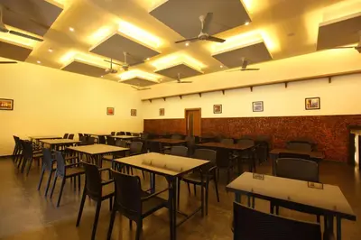 an empty dining room with tables and chairs at Victory Inn Park Residency in Kunnamkulam