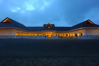 a large white building with a dark roof at Victory Inn Park Residency in Kunnamkulam