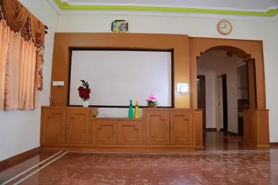 a large screen in the middle of a room at Coimbatore Home Stay & Serviced Apartment in Coimbatore