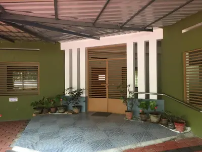 a room with green walls with doors and potted plants at Airavatham Apartments in Guruvāyūr