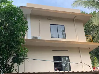 a view of a house with a balcony at Airavatham Apartments in Guruvāyūr