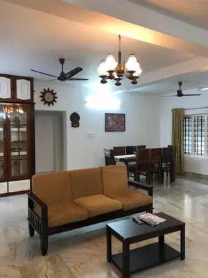 a living room with a couch and a table at Sannidhi Home stay in Guruvāyūr