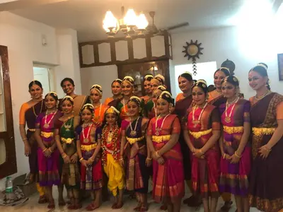 a group of people in traditional dress posing for a picture at Sannidhi Home stay in Guruvāyūr