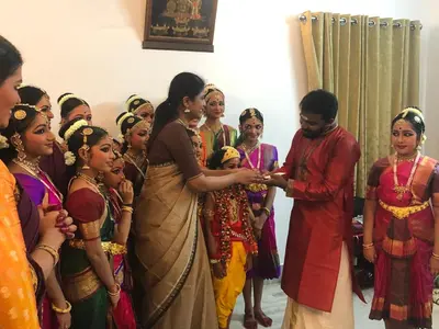 a man and a woman standing next to a group of people at Sannidhi Home stay in Guruvāyūr